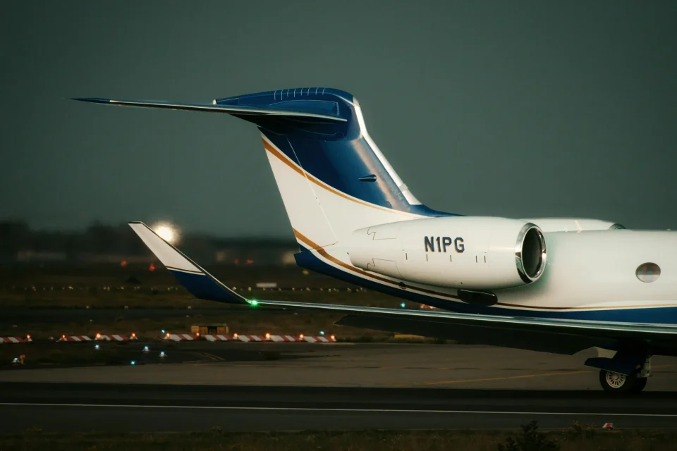 Private jet engine and tail on the apron at dusk