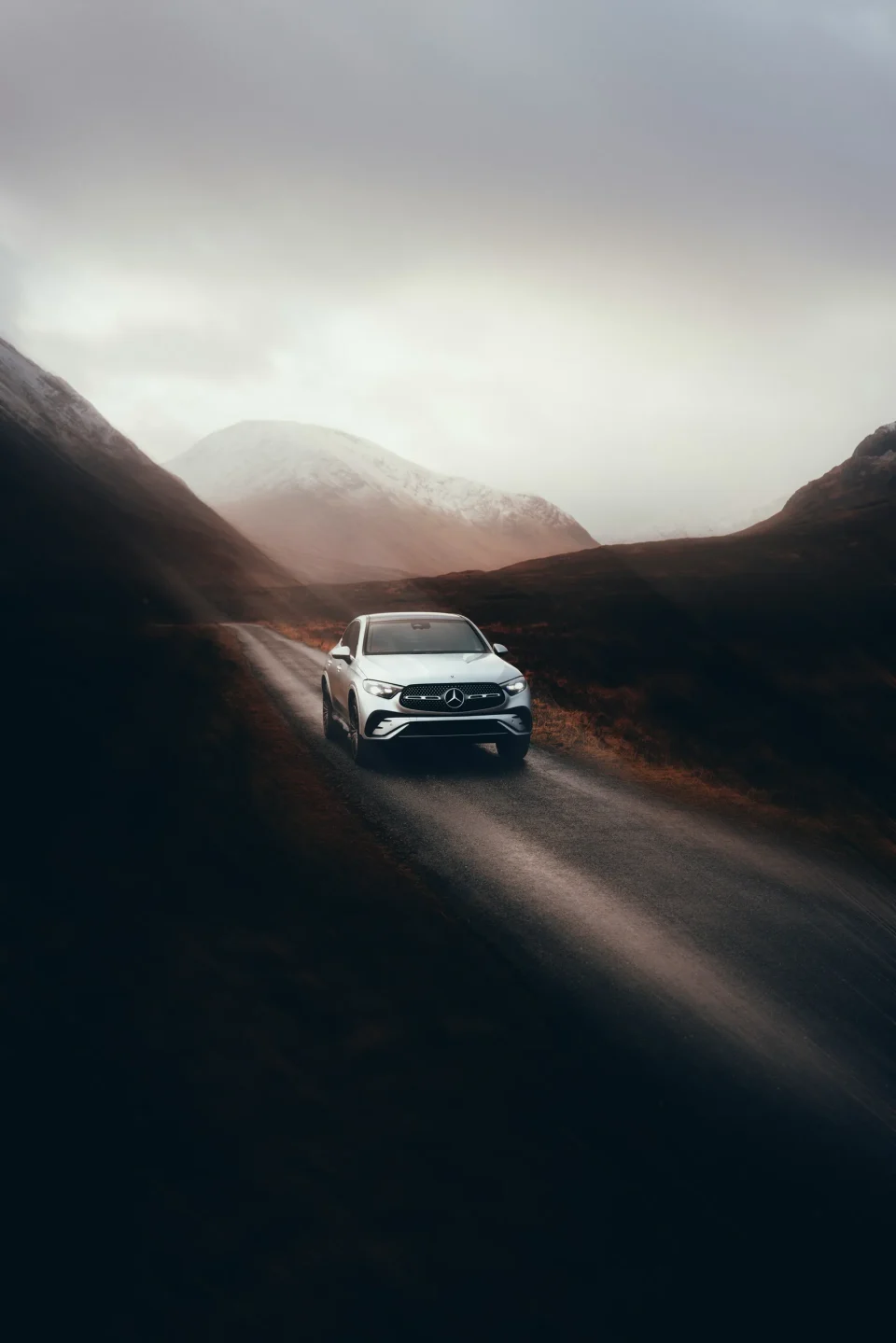 Car on a winding road through mountains