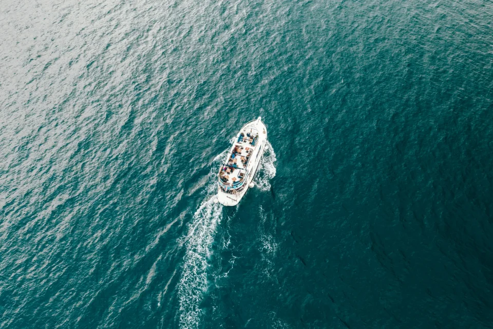 Sailing boat leaving a wake across blue water