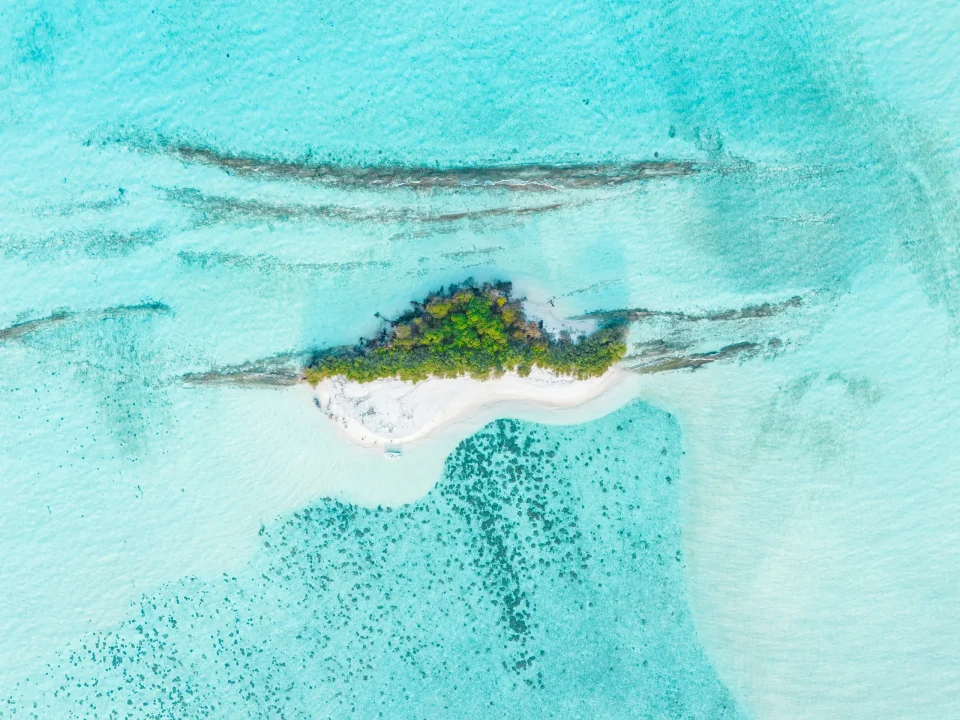 Small island surrounded by turquoise water
