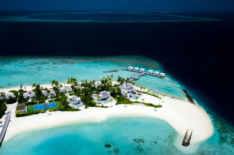 Aerial view of an island resort and turquoise lagoon