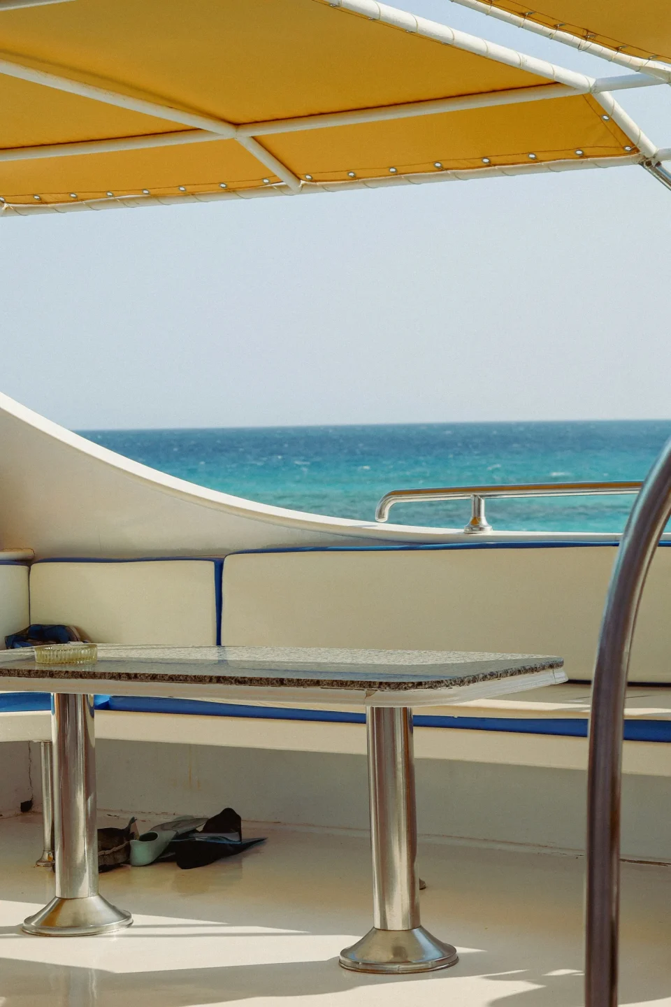 Shaded seating on a boat overlooking the sea