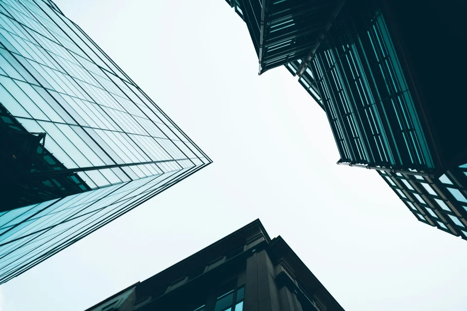 Upward view between contemporary office towers